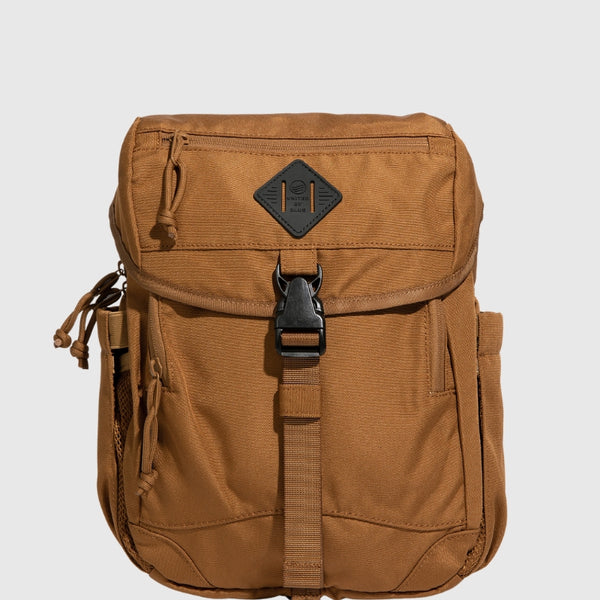Camel (R)evolution™ 9L Sidekick (Front): Tan canvas bag with buckle strap, front pocket, and diamond logo patch