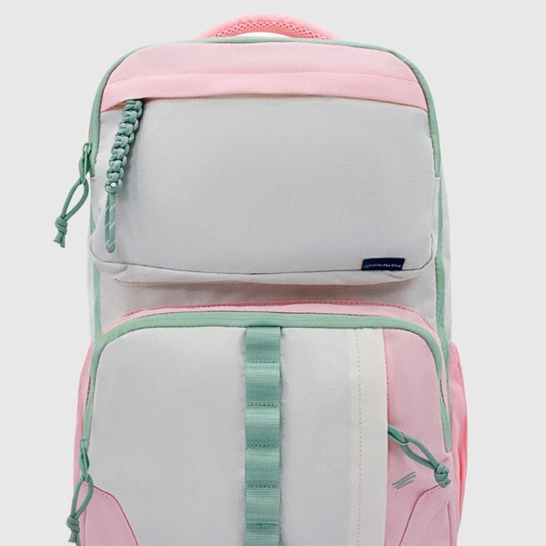 Light Pink (R)evolution™ 25L Transit Pack (Front): Pink and light gray backpack with mint green zippers, straps, and paracord pulls