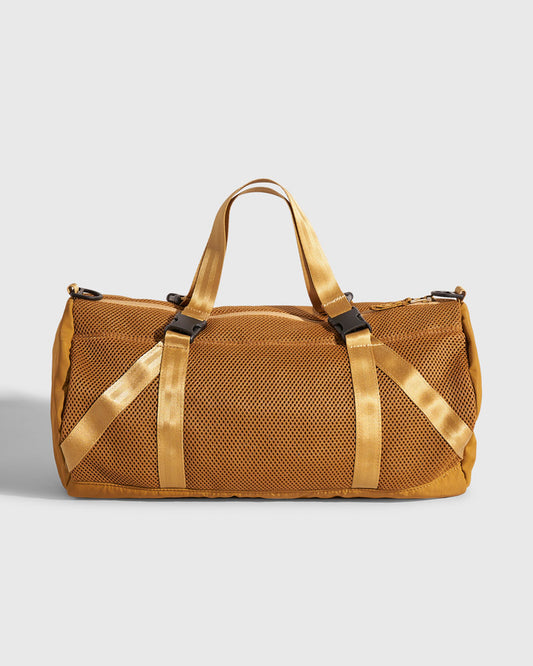Smoky Orchre (Re)active™ 16L Mini Duffle (Front): Golden tan mesh duffle bag with nylon straps and black buckles