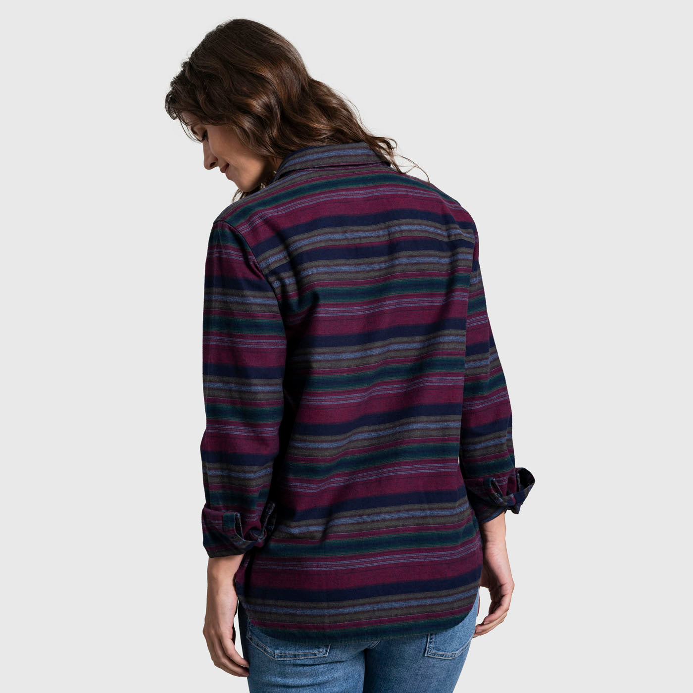 Rhododendron The Responsible Flannel - Impact Collection (Back): Back view of striped flannel shirt in burgundy, navy, blue, and green worn by model with jeans