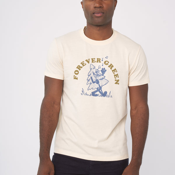 Shortbread Forever Green Graphic Tee (In-use): Man wearing cream tee with blue dancing tree graphic and gold text