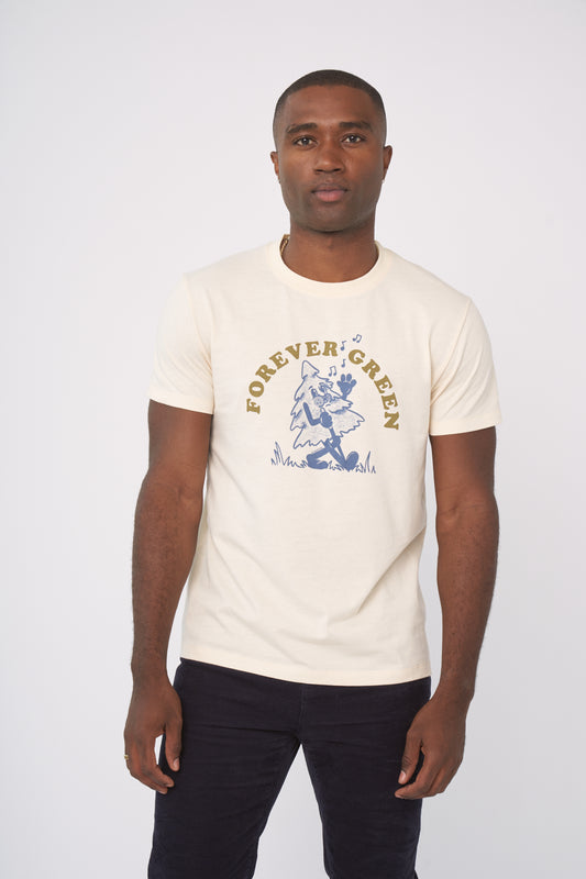 Shortbread Forever Green Graphic Tee (In-use): Man wearing cream tee with blue dancing tree graphic and gold text