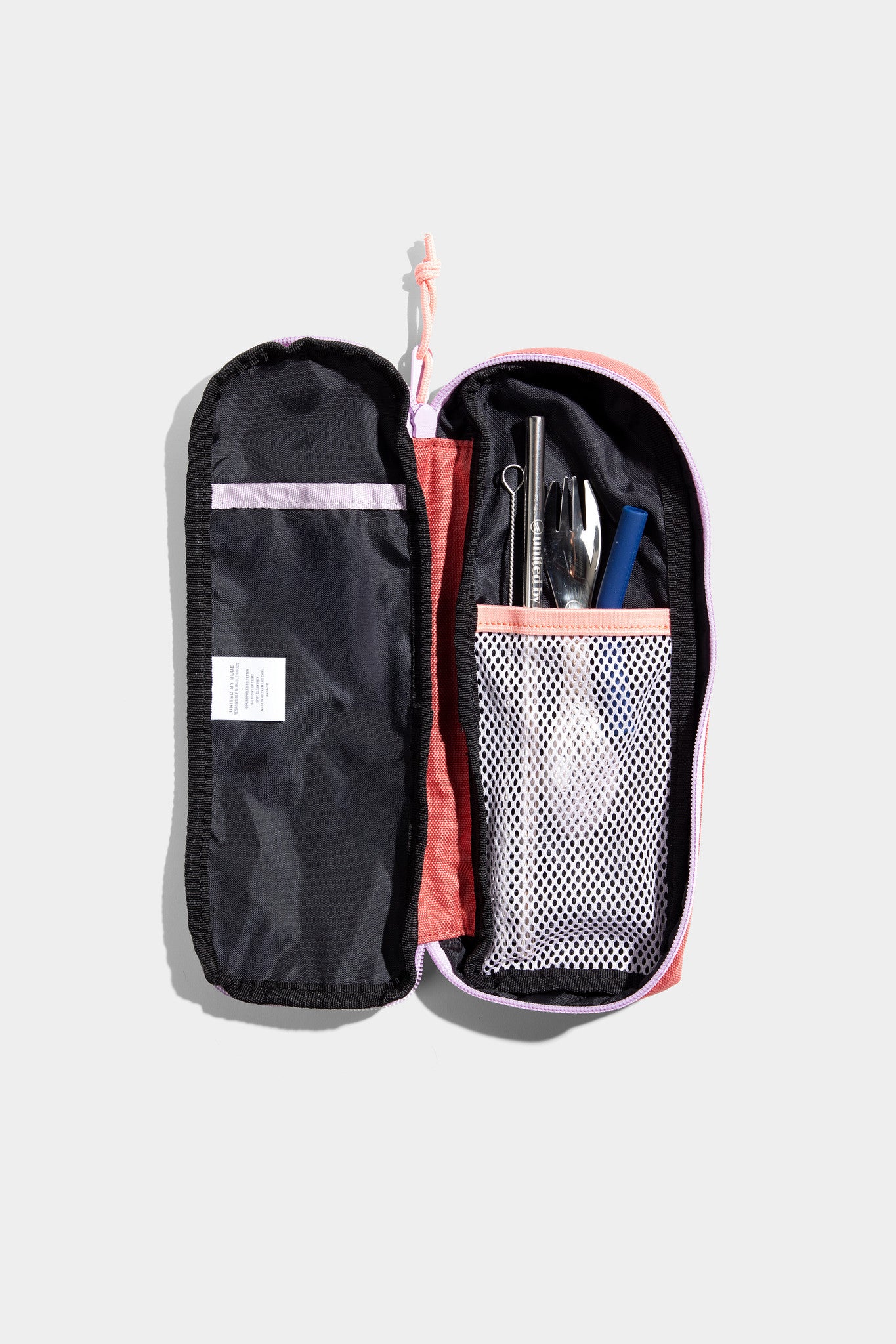 Cortado The Utensil Pack - Perfect for Packed Lunches (Detail): Open coral case with mesh pocket holding utensils, straw, and pen
