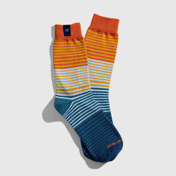 Blue Glass IMPACT COLLECTION - Hemp Blend Socks (Flat-lay): Crew socks with gradient stripes transitioning orange to teal, overlapping pair