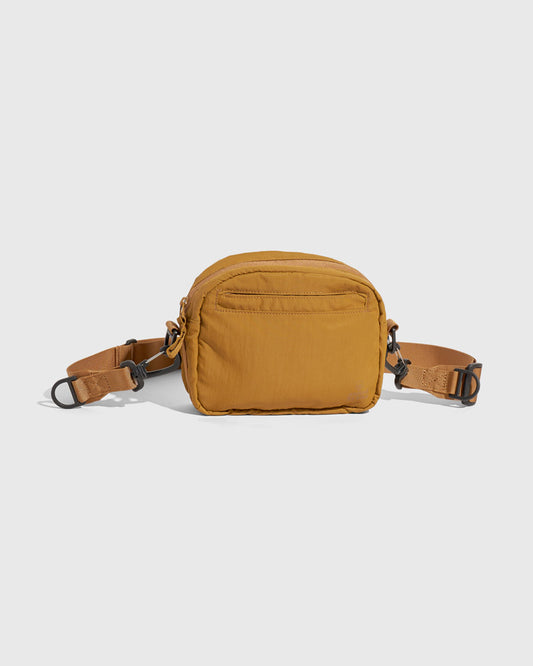 Smoky Ochre (Re)active™ 2L Convertible Crossbody (Back): Golden yellow crossbody bag with back zip pocket and adjustable strap