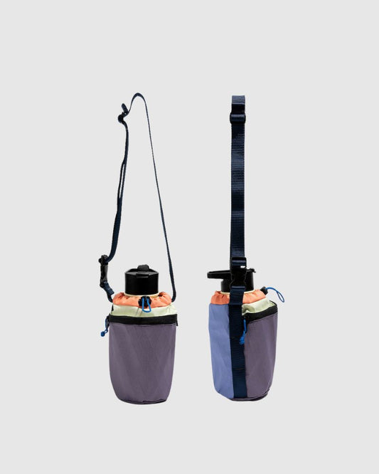 Plum Blue Water Bottle Sling - Westward (Pre-Release) (Angle): Two purple-blue bottle slings shown front and back with drawstring top and adjustable straps
