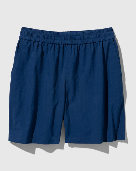 Estate Blue Recycled Sport Short (Flat-lay): Navy blue elastic-waist shorts with side pockets and mid-thigh length