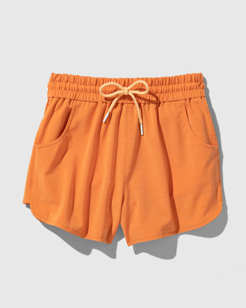 Orange Ochre The Responsible Swim Short (Flat-lay): Orange drawstring shorts with elastic waistband and two side pockets