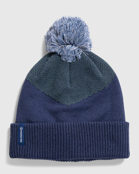 NAVY Recycled Chevron Pom Beanie (Flat-lay): Navy knit beanie with teal chevron panel, pom-pom, and folded cuff