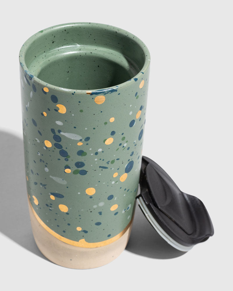 Juniper 10 oz. Insulated Stoneware Travel Mug (Detail): Sage green speckled mug with gold and blue splatter, lid removed