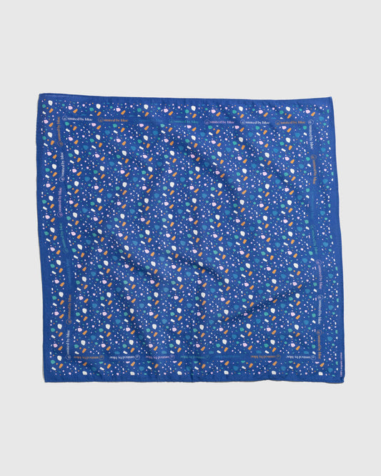 Lagoon Organic Bandana (Flat-lay): Royal blue bandana with scattered white, pink, teal, and orange shapes