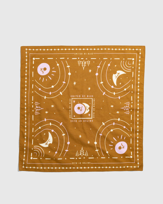 Smoky Ochre Organic Bandana (Flat-lay): Golden ochre square bandana with celestial sun, moon, and star print
