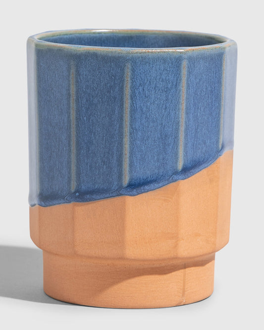 Cobalt 8 oz. Stackable Stoneware Tumbler (Angle): Faceted ceramic tumbler, upper half blue glaze, lower half unglazed terracotta