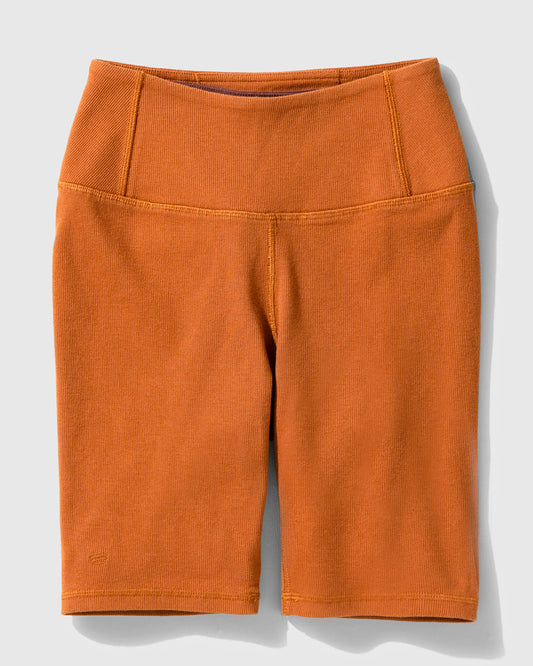 Cinnamon EcoKnit™ Ribbed Bike Short (Flat-lay): Burnt orange ribbed bike shorts with wide waistband and seam detailing