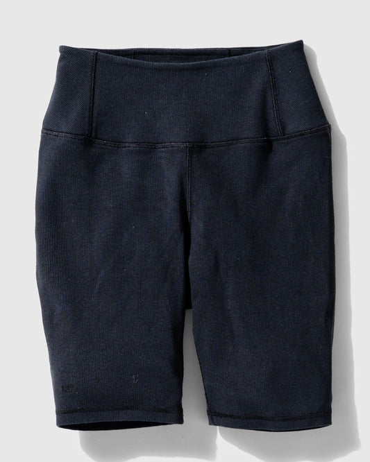 Black EcoKnit™ Ribbed Bike Short (Flat-lay): Dark navy ribbed bike shorts with wide waistband and side pockets