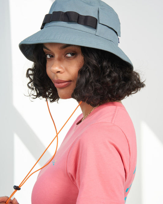 Sky Blue Organic Bucket Stash Hat (In-use): Woman wearing light blue bucket hat with black grosgrain band and orange chin cord