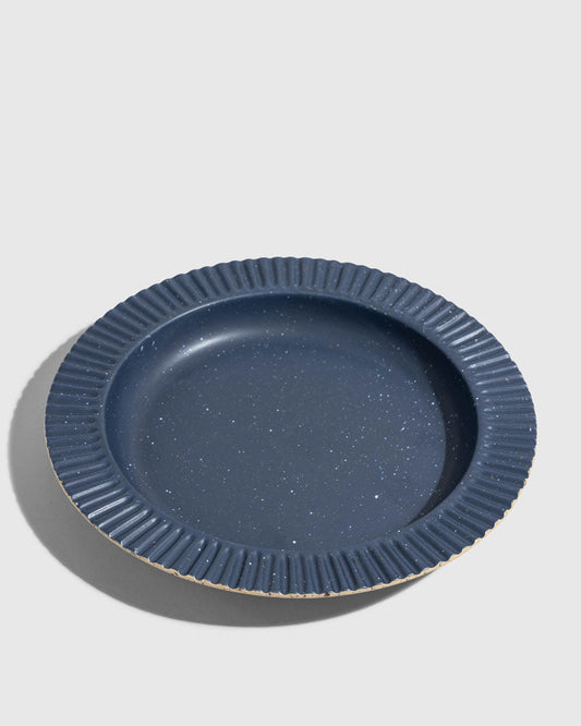 Slate Stoneware Stackable Plate (Angle): Round dark blue speckled plate with ribbed fluted rim and unglazed edge