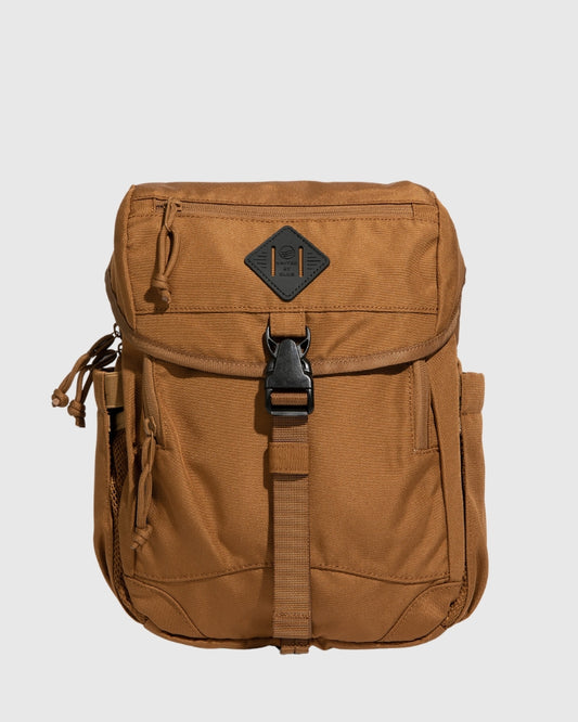 Camel (R)evolution™ 9L Sidekick (Front): Tan canvas bag with buckle strap, front pocket, and diamond logo patch