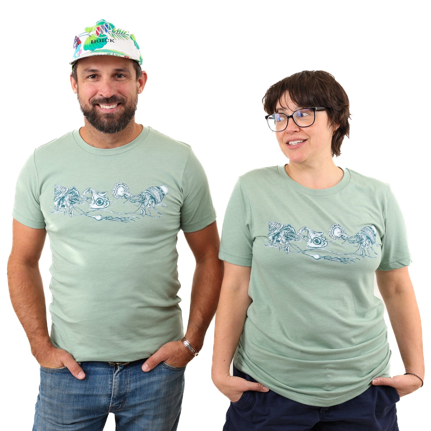 Heather Sage What We Save Graphic Tee - Slow Loris x United By Blue (In-use): Man and woman wearing sage green tees with hermit crab graphic print