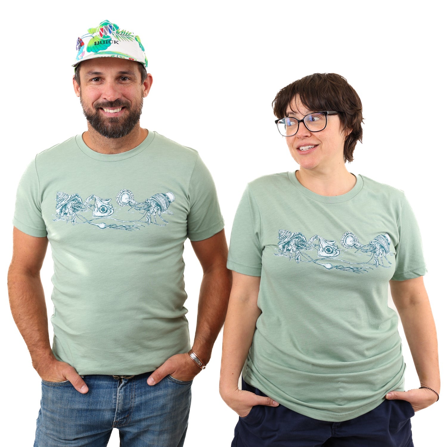 Heather Sage What We Save Graphic Tee - Slow Loris x United By Blue (In-use): Man and woman wearing sage green tees with hermit crab graphic print