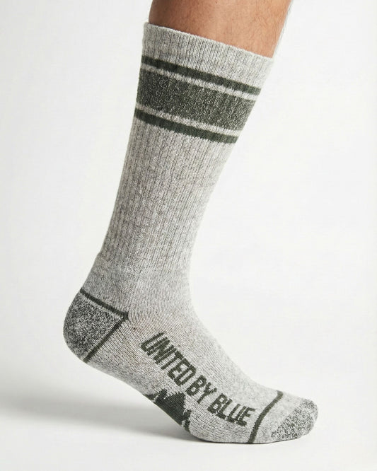 Wild Green Ultimate Bison Boot Sock - Imperfect Packaging (In-use): Gray ribbed crew sock with olive stripes and branded sole on foot