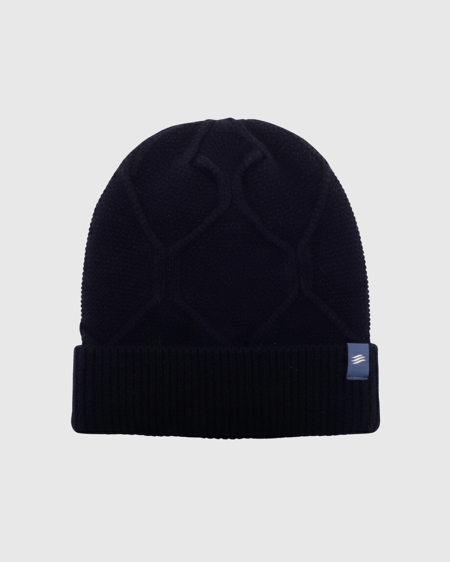 Navy Yak Cable Knit Beanie (Front): Dark navy knit beanie with cable pattern and ribbed cuff, small label