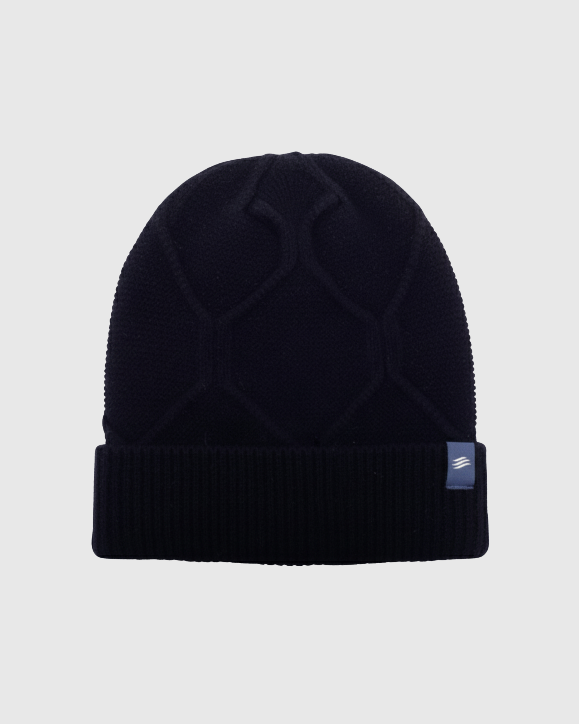 Navy Yak Cable Knit Beanie (Front): Dark navy knit beanie with cable pattern and ribbed cuff, small label