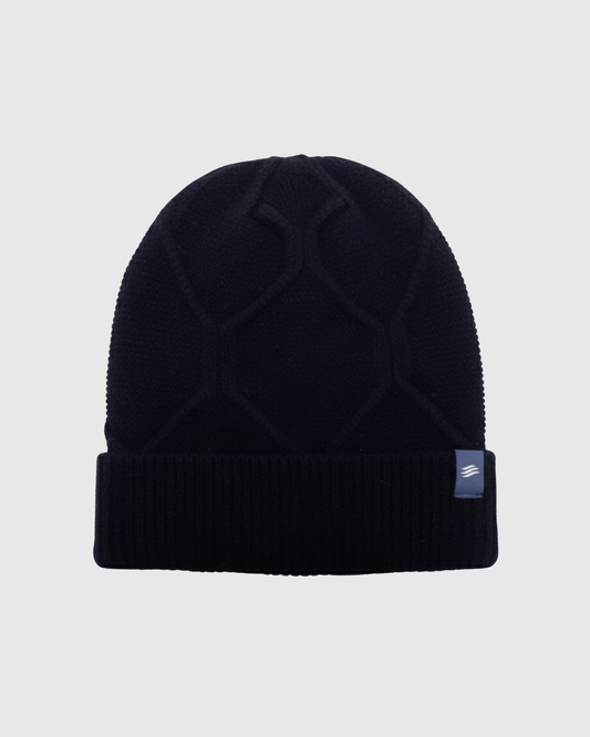 Navy Yak Cable Knit Beanie (Front): Dark navy knit beanie with cable pattern and ribbed cuff, small label