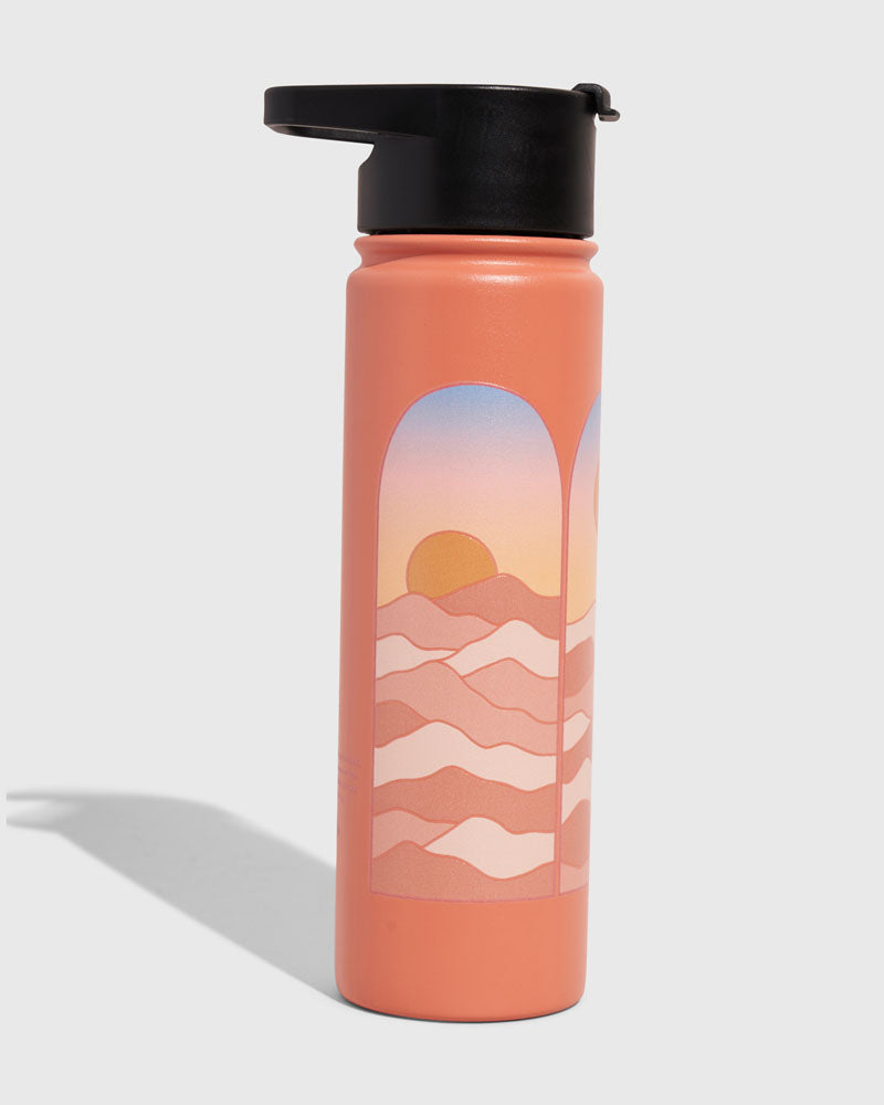 Sherbet - Sunrise Bottle - 22 Oz. Insulated Stainless Steel (Angle): Coral bottle with arched sunrise scene, wavy hills, black flip lid