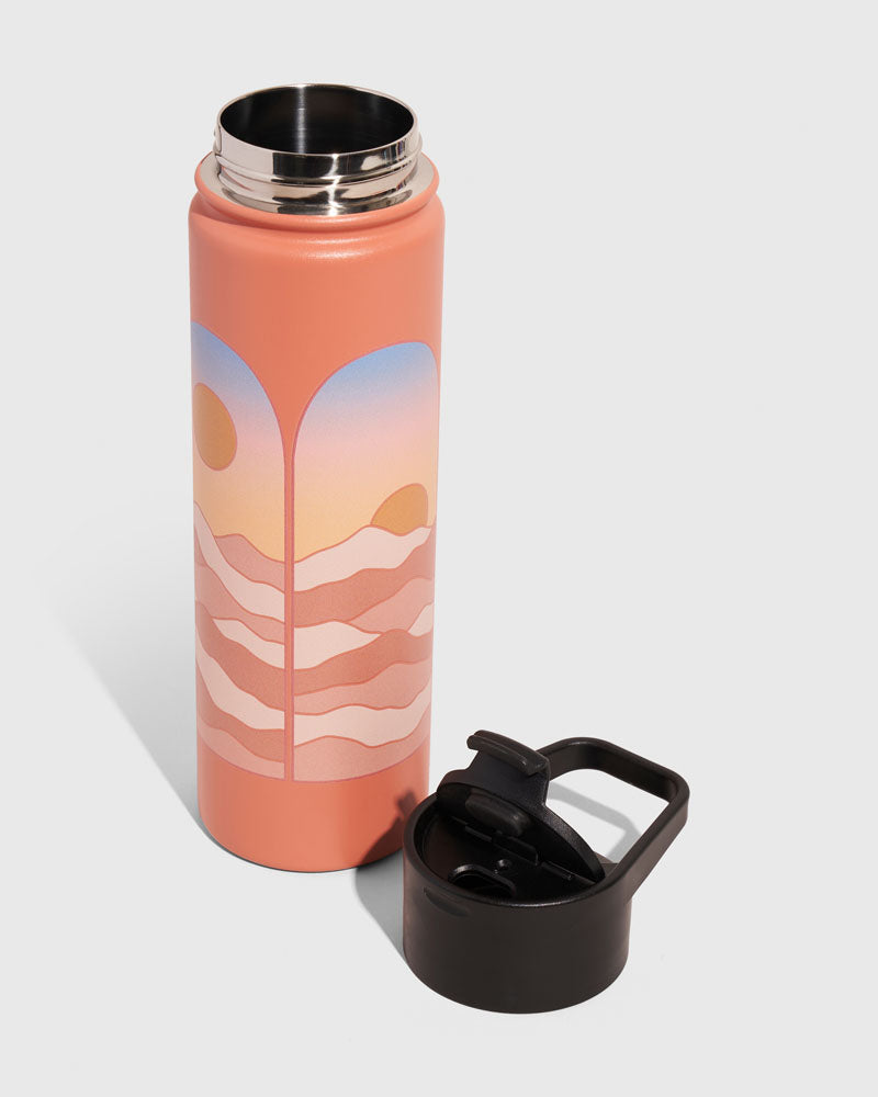Sherbet - Sunrise Bottle - 22 Oz. Insulated Stainless Steel (Angle): Open coral bottle with sunset landscape graphic, black carry cap beside it