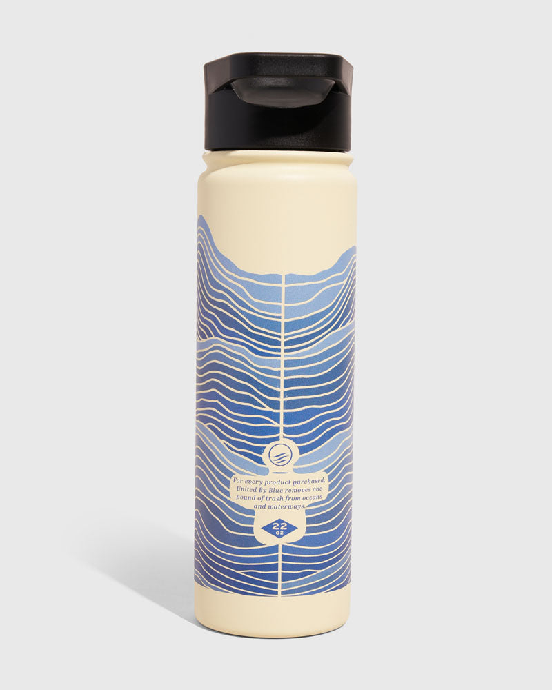 Eggshell - Waves Bottle - 22 Oz. Insulated Stainless Steel (Front): Cream bottle with blue wave pattern, black flip-top lid, 22oz label
