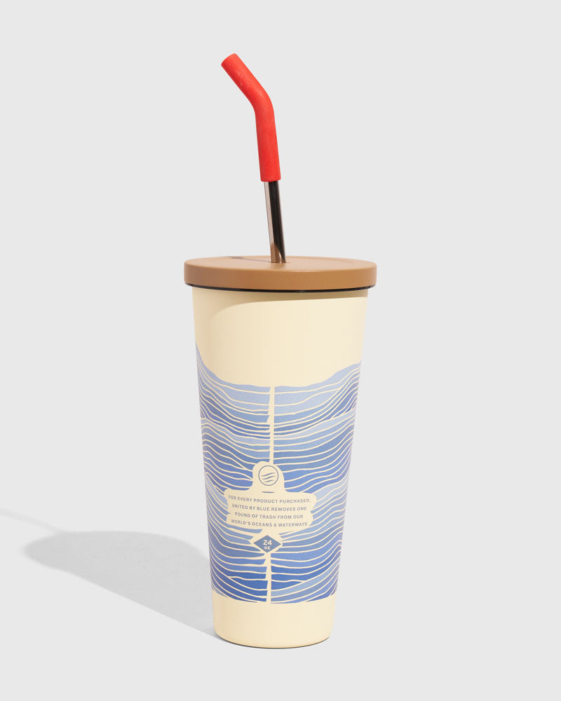 Eggshell - Waves 24 oz Insulated Steel Straw Tumbler (Angle): Cream tumbler with blue wave print, tan lid, red-tipped metal straw