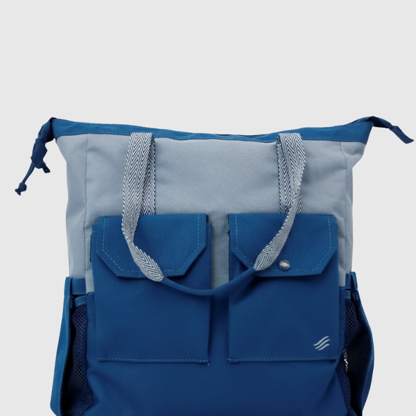 Blue (R)evolution™ 27L Utility Convertible Tote (Front): Two-tone tote with gray top, navy bottom, dual front pockets, woven handles