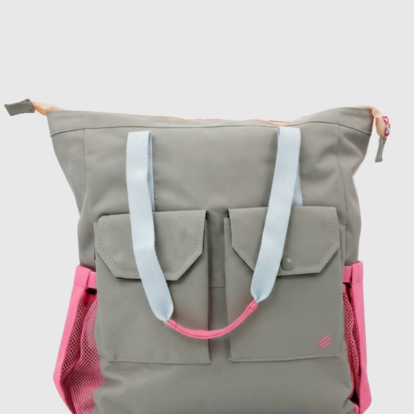Lt Gray (R)evolution™ 27L Utility Convertible Tote (Front): Gray tote with light blue straps, pink accents, and dual front pockets