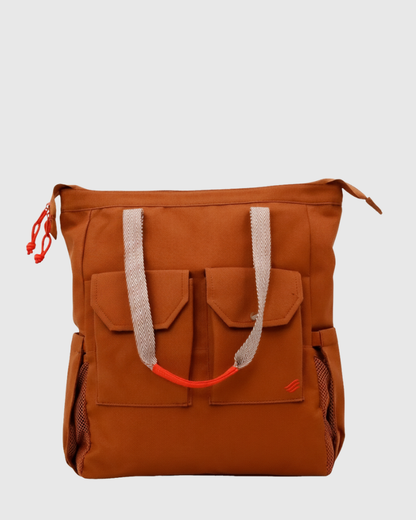 Rustic Caramel (R)evolution™ 27L Utility Convertible Tote (Angle): brown tote with red accents on white
