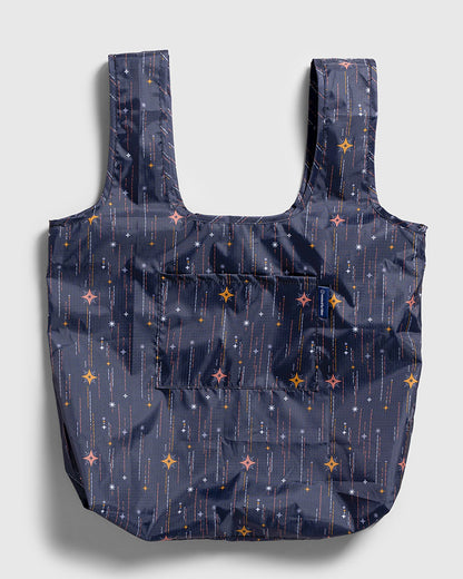 Obsidian The Packable Tote (Flat-lay): Dark navy tote with star and sparkle print, two handles, front pocket