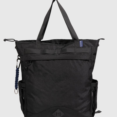 Black (R)evolution™ 25L Convertible Carryall (Front): Black tote with top handles, front zipper pocket, mesh side pocket, carabiner clip