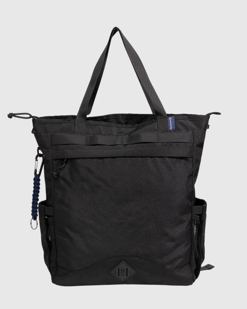 Black (R)evolution™ 25L Convertible Carryall (Front): Black tote bag with top handles, front zipper pocket, mesh side pocket, carabiner clip, and logo patch