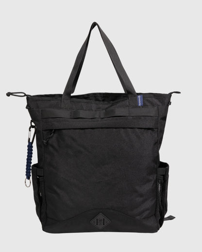 Black (R)evolution™ 25L Convertible Carryall (Front): Black tote bag with top handles, front zipper pocket, mesh side pocket, carabiner clip, and logo patch