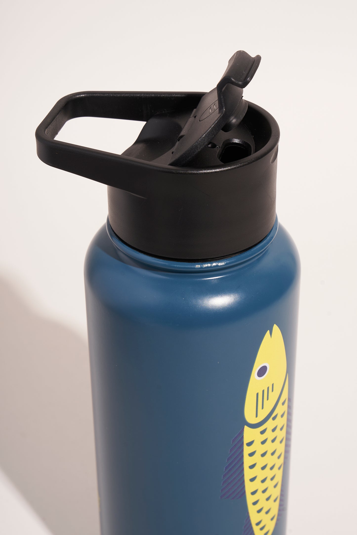Rainstorm - Fish Bottle - 23 Oz. Insulated Stainless Steel (Detail): Steel-blue bottle top showing black flip-top lid with carry handle and yellow fish graphic