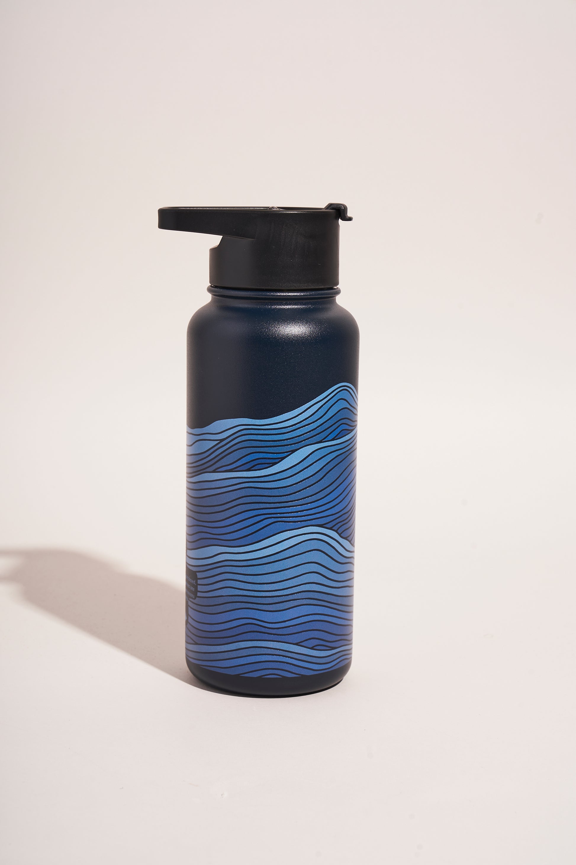 Lake - Waves Bottle - 23 Oz. Insulated Stainless Steel (Front): Dark navy bottle with blue wave pattern and black spout lid