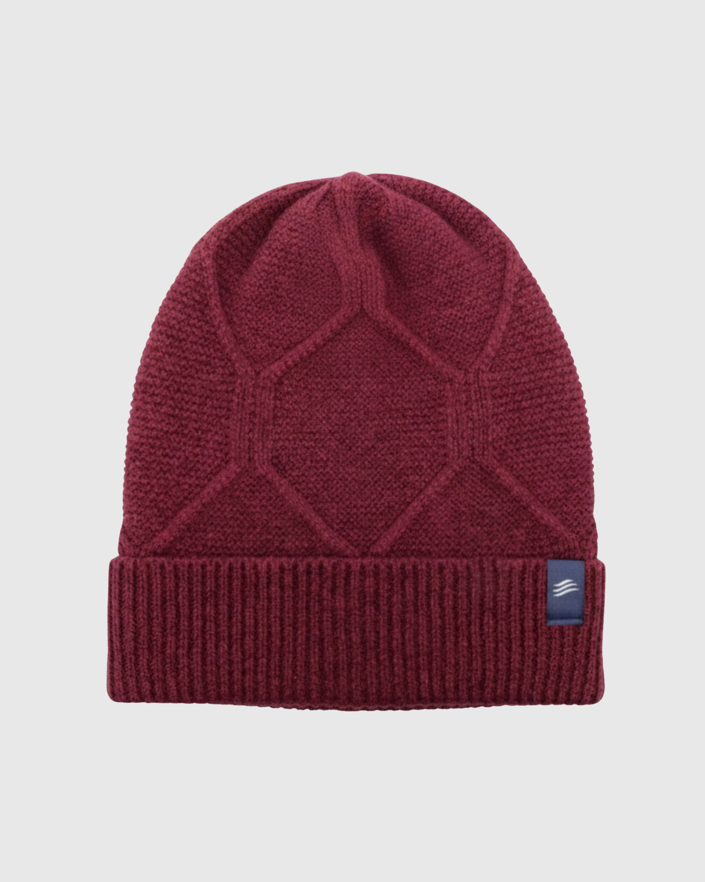 Berry Yak Cable Knit Beanie (Flat-lay): Dark red knit beanie with geometric cable pattern and ribbed cuff