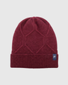 Berry Yak Cable Knit Beanie (Flat-lay): Dark red knit beanie with geometric cable pattern and ribbed cuff