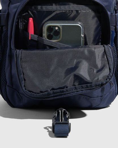 (R)evolution™ 9L Sidekick (Detail): Navy interior pocket open, showing phone, red pen, and buckle strap