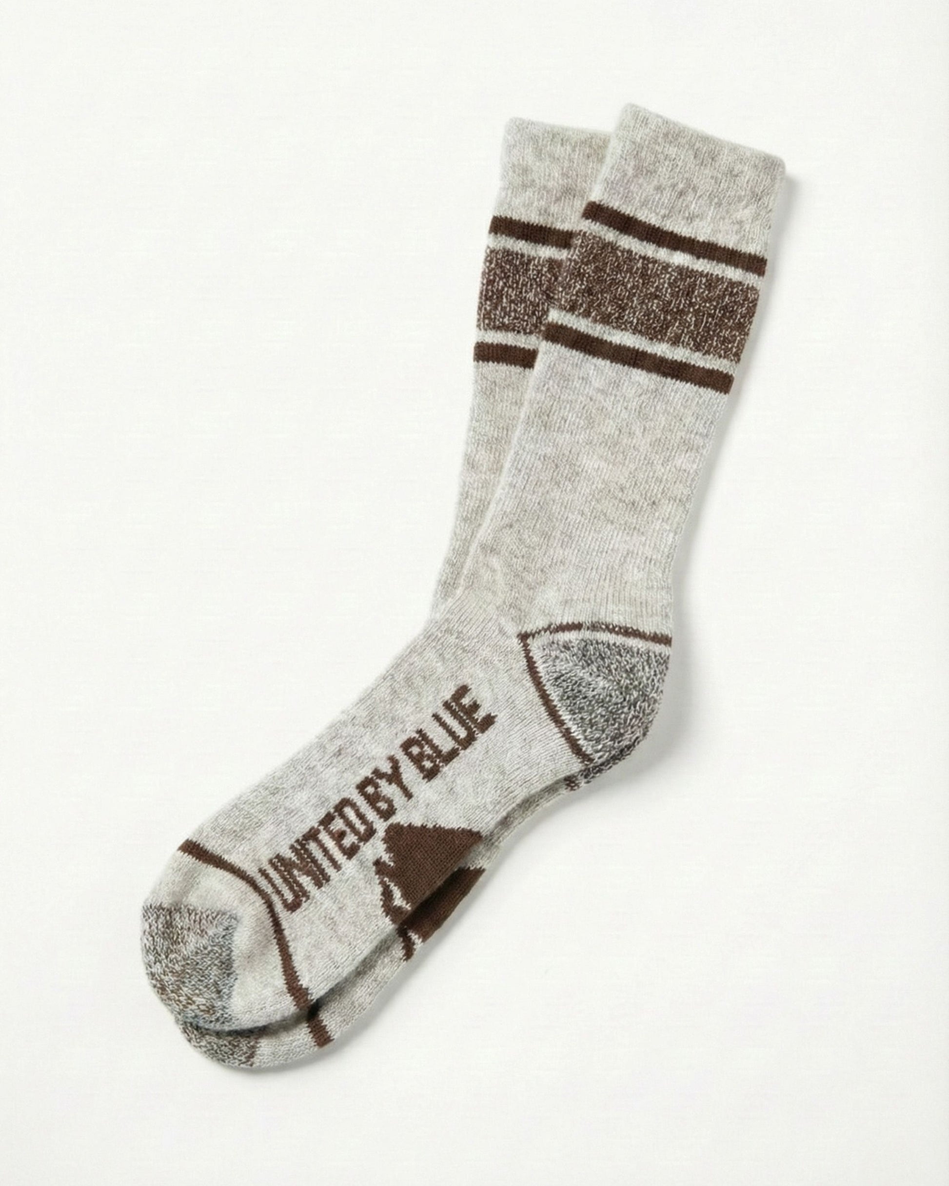 Coffee Ultimate Bison Boot Sock - Imperfect Packaging (Flat-lay): Light gray crew sock with brown stripes, heel, toe, and logo