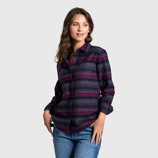 Rhododendron The Responsible Flannel - Impact Collection (Angle): Woman wearing striped burgundy navy flannel shirt with blue jeans, hands in pockets