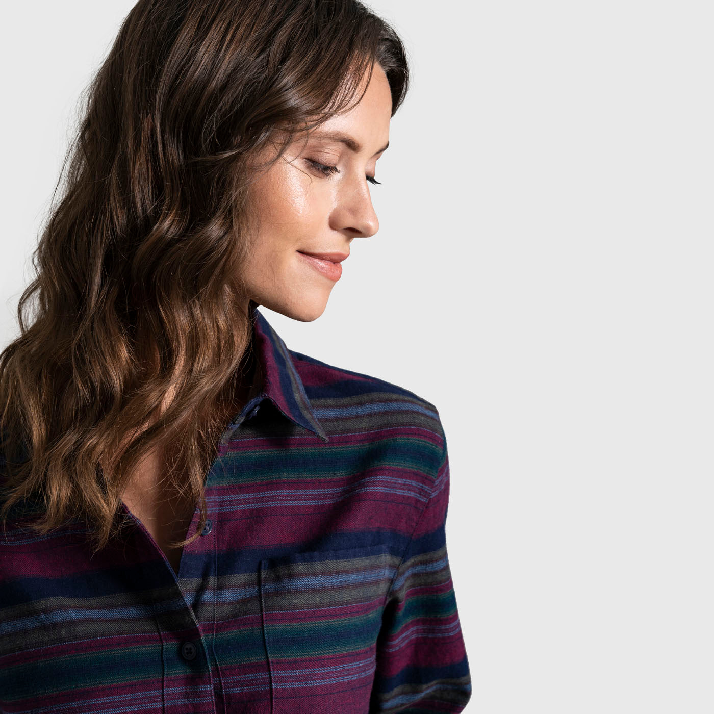 Rhododendron The Responsible Flannel - Impact Collection (In-use): Woman wearing striped flannel shirt with navy, magenta, and green horizontal stripes