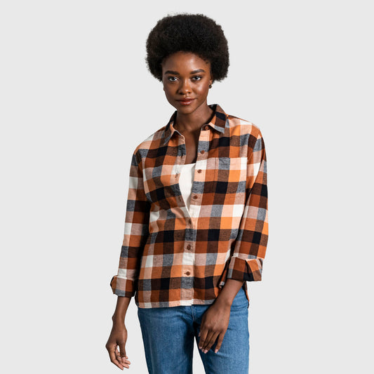 Sunburn The Responsible Flannel - Impact Collection (In-use): Woman wearing open orange black white plaid flannel shirt over white top