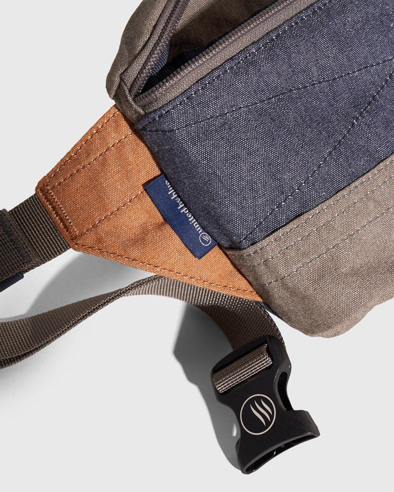 Camel Deadstock (R)evolution™ Canvas Fanny Pack (Detail): Close-up showing navy, camel, and tan canvas panels with branded label and buckle