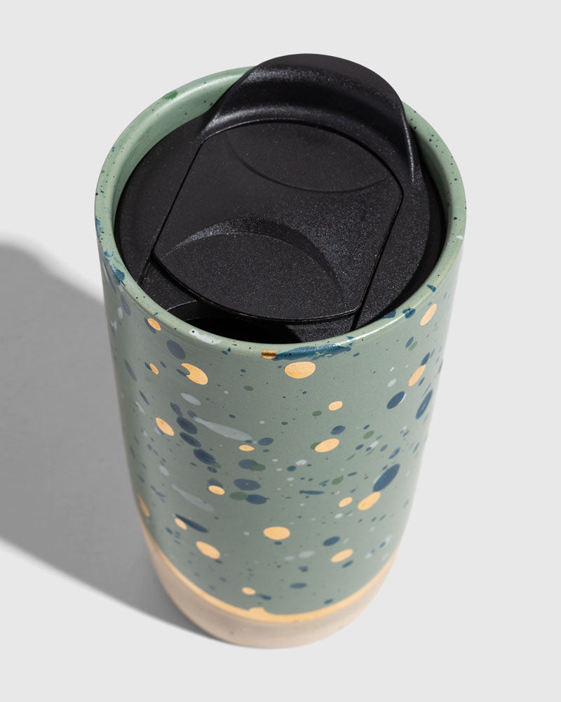 Juniper 10 oz. Insulated Stoneware Travel Mug (Detail): Green ceramic mug with gold and blue speckles, black travel lid